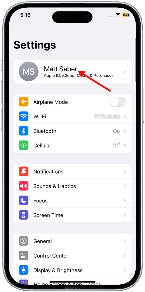 Once you have opened the Settings app, tap on your name at the top of the screen. This will open your iCloud settings page.